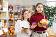 © JackF - Positive teenage girl and her mother choosing pasta in grocery store