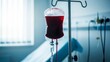 © Ehtisham - Blood bag infusion in a hospital room with medical equipment in the background.