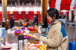 © leungchopan - Lady lighting incense and praying at temple
