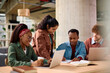© Drazen - Happy multiracial friends learning together at university.