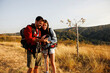 © Impact Photography - Couple using smart phone while taking a hiking  break in nature