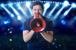 © New Africa - Referee shouting in megaphone at stadium during match