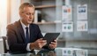 © Justlight - Executive examining detailed portfolio breakdown on a tablet with indistinct business documents and graphs softly blurred behind emphasizing strategic financial planning.