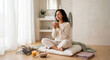 © Virginie Verglas - Serene woman enjoying mindful self-care morning ritual with herbal tea and aromatherapy in bright minimalist bathroom