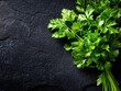 © Лаra Wladdim - Fresh green parsley. Against a black stone background. Top view.