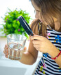 © yanadjan - Children look at the water with a magnifying glass. Selective focus.