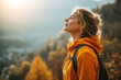 © Link Parker - Beautiful woman standing on a mountain trail with eyes closed breathing fresh air and feeling serene during an autumn hike