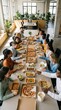 © Lustre Art Group  - Coworkers sitting at long table eating delivered meals and pizza together in office. Concept of food delivery service, bulk orders, workplace convenience and team interaction.
