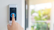 © Bonsales - Person pressing smart video doorbell button, activating modern home security and smart access control system