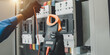 © Nonthanat - Electrical equipment maintenance service engineer Engineers carry AC voltmeters to check voltage at breaker terminals and inspect switchgear.