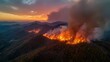 © Rehan - Aerial view of a forest fire burning on a mountain during sunset with smoke rising