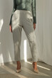 © triocean - Beautiful model in Fashion Atelier Wearing Green V-Neck Cotton Long-Sleeve Shirt With Grey Cropped Cigarette Trousers – Stylish Comfortable Fall Winter Fashion Concept