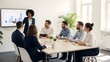 © Alula - Diverse business professionals collaborating in a clean, minimalist office, focused on a data presentation for strategic planning and team success