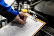 © zphoto83 - Closeup of mechanic hand completing car maintenance log on clipboard