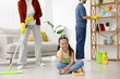 © New Africa - Spring cleaning. Family tidying up living room together