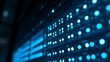© wenqing - Close-up of glowing blue server rack lights creating an abstract technological pattern on a dark background.