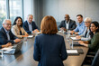 © Rohan Katwe - A diverse group of professionals engage in a meeting around a wooden table, fostering collaboration and problem-solving in a corporate setting.
