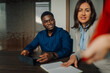 © Ljustina - Diverse business team collaborating during office meeting