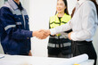 © laddawan - Business handshake seals construction deal between contractor and client. Teamwork, trust, partnership, and project success