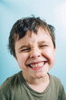 © Westend61 - Portrait of smiling child in green shirt looking at camera