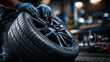 © AnastasiiaAkh - Mechanic changing car tire in auto service workshop closeup wheel replacement automotive maintenance repair concept