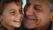 © Future Vision - Smiling boy and grandfather pressing cheeks together at home, wearing maroon top and grey sweater