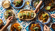 © Vector Vision - A table with various mexican dishes and hands reaching for food