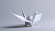 © Darya - White origami crane against low light, a paper bird symbolizing peace, hope and Japanese art tradition