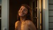 © Future Vision - Smiling adult woman standing at house threshold, showing bare shoulders, with white doorknob