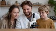© Bussakon - A family including a mother father in a lab coat and young son are joyfully engaged in scientific learning with a microscope at home