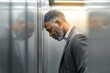 © Vivid_Vision - Stressed businessman in elevator, burnout and corporate pressure concept