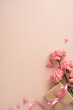 © ActionGP - Happy Mother's Day vertical composition featuring pink carnations and a ribboned gift box with paper heart cutouts on a soft pastel background ideal for greeting cards and social posts