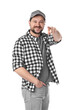 © New Africa - Smiling long-haul truck driver in baseball cap and checkered shirt pointing at camera on white background