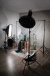 © Pixel-Shot - Interior of photo studio with professional equipment, plaid and chair