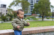 © leungchopan - Little child playing with dandelions in park