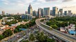 © soem - A high-angle view captures a sprawling cityscape of Bangalore, India, dominated by modern skyscrapers and a prominent flyover.