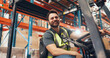 © peopleimages.com - Confidence, forklift and man with portrait in warehouse, industrial logistics and inventory management. Flare, freight industry and worker with vehicle for stock distribution, smile and storage depot