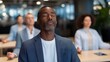 © forenna - Diverse group of coworkers practice guided breathing exercises together in modern office break room during lunch hour, smartphones displaying meditation timer apps on table, ideal for workplace