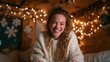 © svastix - A joyful young woman with curly hair smiling warmly, situated in a cozy environment adorned with twinkling lights, radiating a sense of comfort and festive spirit.