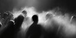 © Amazight - An abstract, mysterious, and blurry image of a crowd of people in dark. The individuals seem to be moving through smoke or fog, adding an air of intrigue