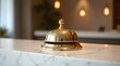 © Nathan - Shiny Gold Hotel Reception Bell on Marble Countertop in Elegant Modern Interior