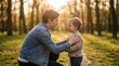 © Pavel - Father comforting crying toddler boy in forest at sunset