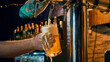 © Lustre Art Group  - Bartender pouring draft beer into glass mug with foam dripping close up. Concept of beverage service promo, drink preparation visual, bar marketing content, menu ads, hospitality branding.