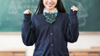 © Trickster* - 黒板の前でガッツポーズをする女子学生 やる気や達成の学習イメージ, Female Student Celebrating Success in Classroom Fist Pump Learning Concept