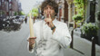 © Krakenimages.com - Man chef in white uniform holding rolling pin and finger to lips for silence on street; quiet secrecy.