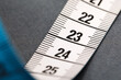 © New Africa - One measuring tape on grey background, closeup