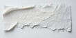 © antishock - Crumpled paper strip rests upon white surface. Texture appears fragile, torn edges visible. Minimalist composition, stark contrast exists.