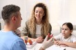 © New Africa - Endocrinologist in medical gloves consulting woman with her daughter and showing model of thyroid gland at white desk in clinic