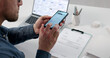 © Andrey Popov - Businessman Capturing Invoice Image With Smartphone For OCR Processing