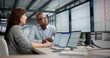 © Andrey Popov - Two Professionals Collaborating On Spreadsheets And Software In Busy Office